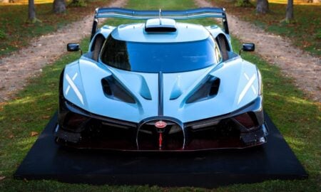 A sleek, white bugatti racecar on display.