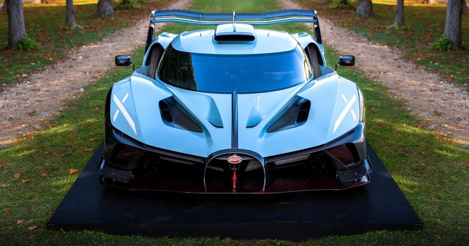A sleek, white bugatti racecar on display.