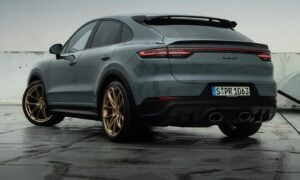 a grey porsche cayen is parked in a parking lot