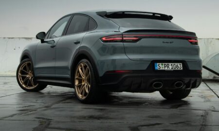 a grey porsche cayen is parked in a parking lot