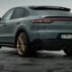 a grey porsche cayen is parked in a parking lot