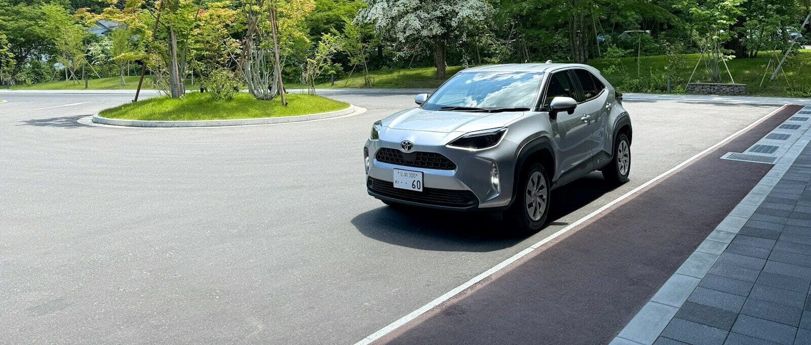 Modern silver suv parked in a sunny outdoor lot