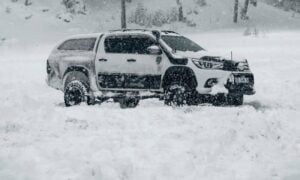 a truck is parked in a snowy field