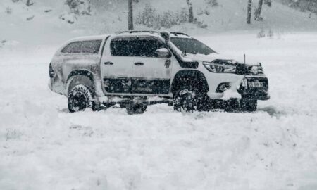 a truck is parked in a snowy field