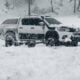 a truck is parked in a snowy field