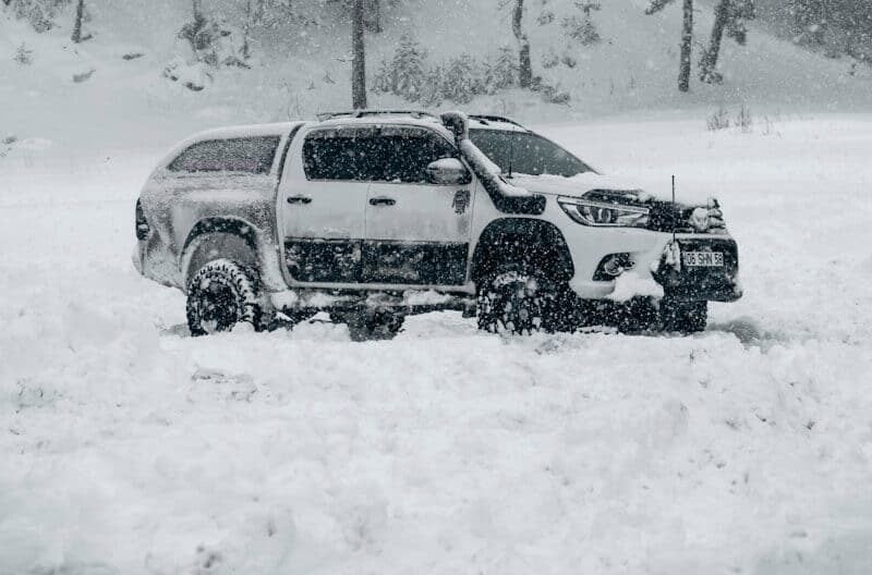 a truck is parked in a snowy field