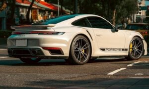 a white sports car parked on the side of the road
