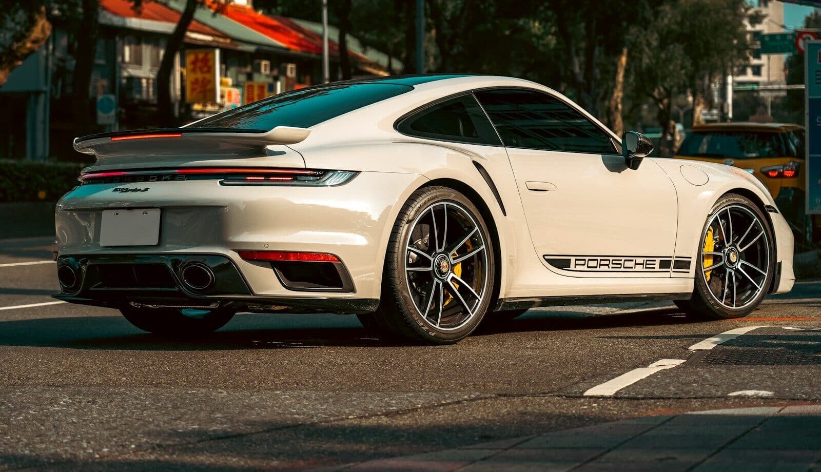 a white sports car parked on the side of the road