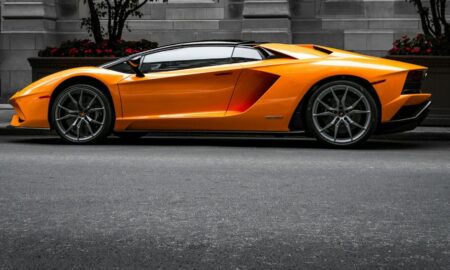 orange sports car on roadway