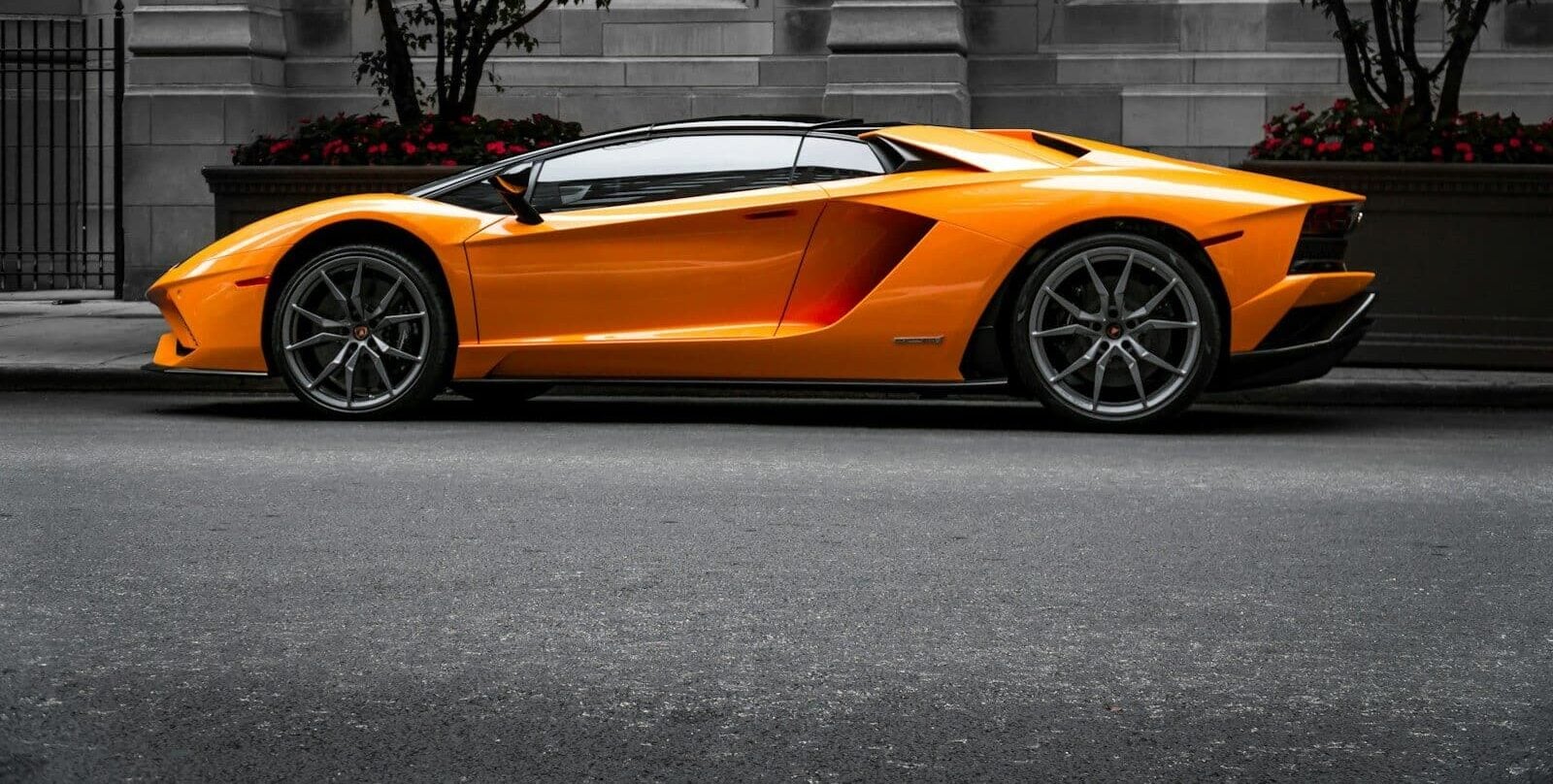 orange sports car on roadway