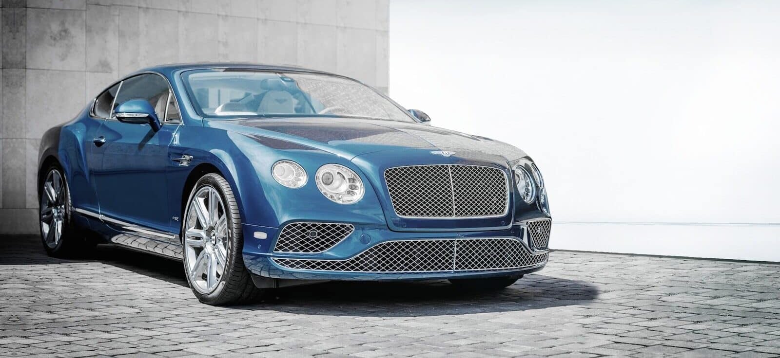 blue coupe on road