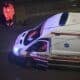 Paramedic stands near an ambulance at night