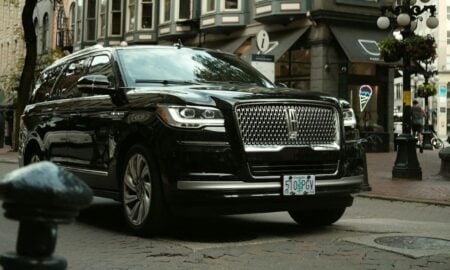 a black car parked on the side of the road