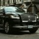 a black car parked on the side of the road
