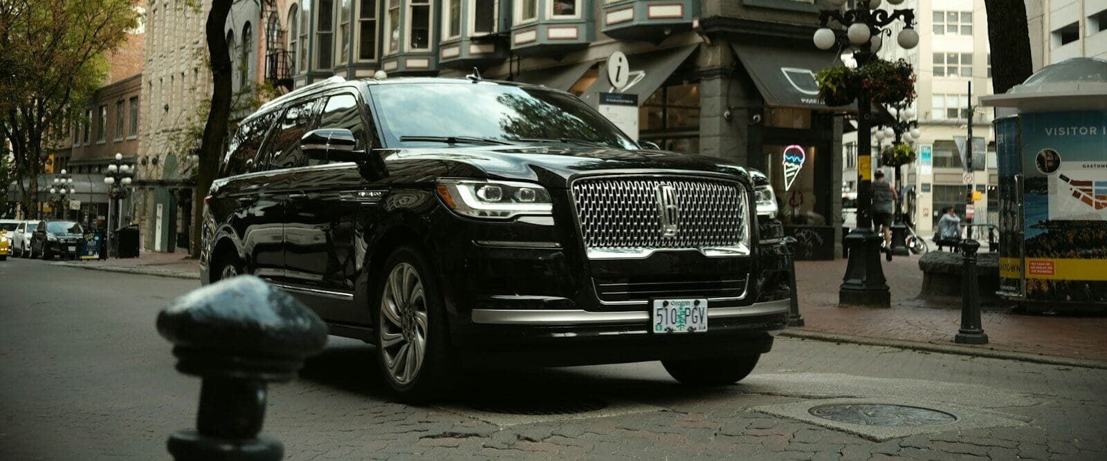 a black car parked on the side of the road