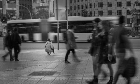 a group of people walking across a street