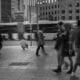 a group of people walking across a street