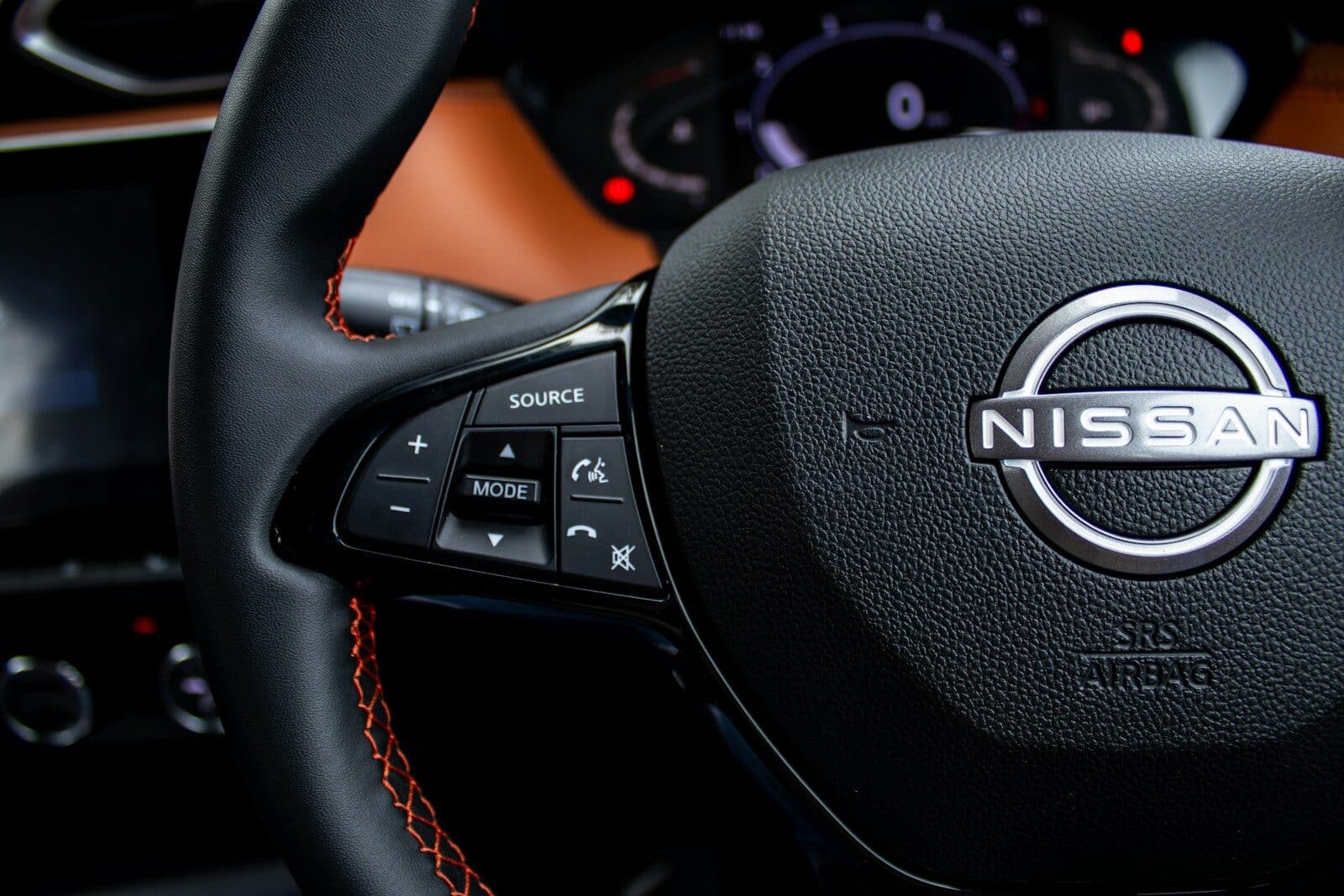 Close-up of a nissan steering wheel with controls