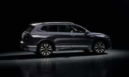 Dark blue suv parked on a reflective surface